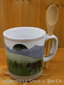 mug with a spoon in the woods