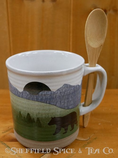 mug with a spoon in the woods
